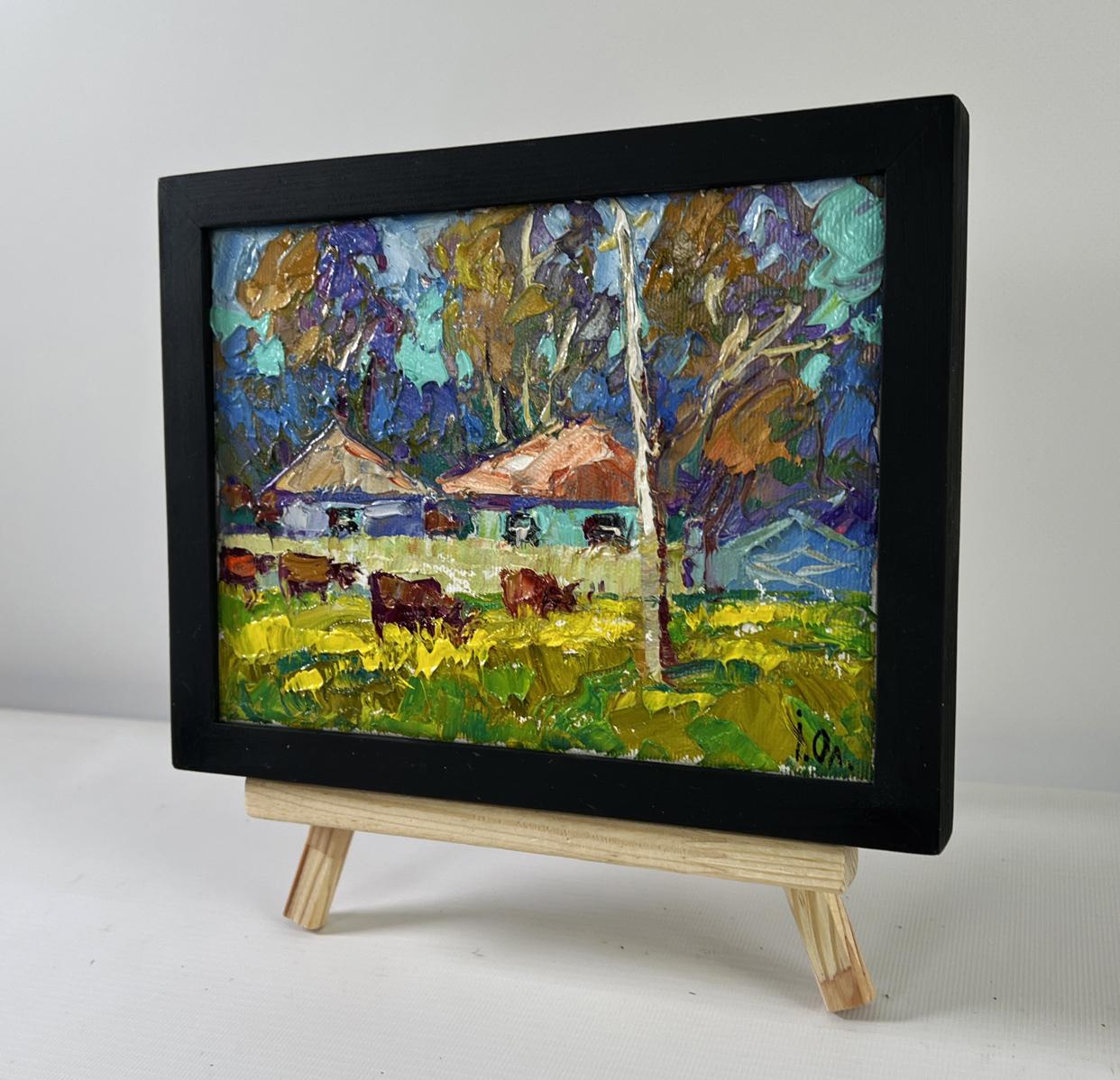 Oil painting The herd returns by Oleksiy Ivanyuk in black frame on easel