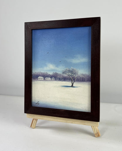 Dark wood-framed oil painting of snowy winter landscape at dawn by Andrei Bagno