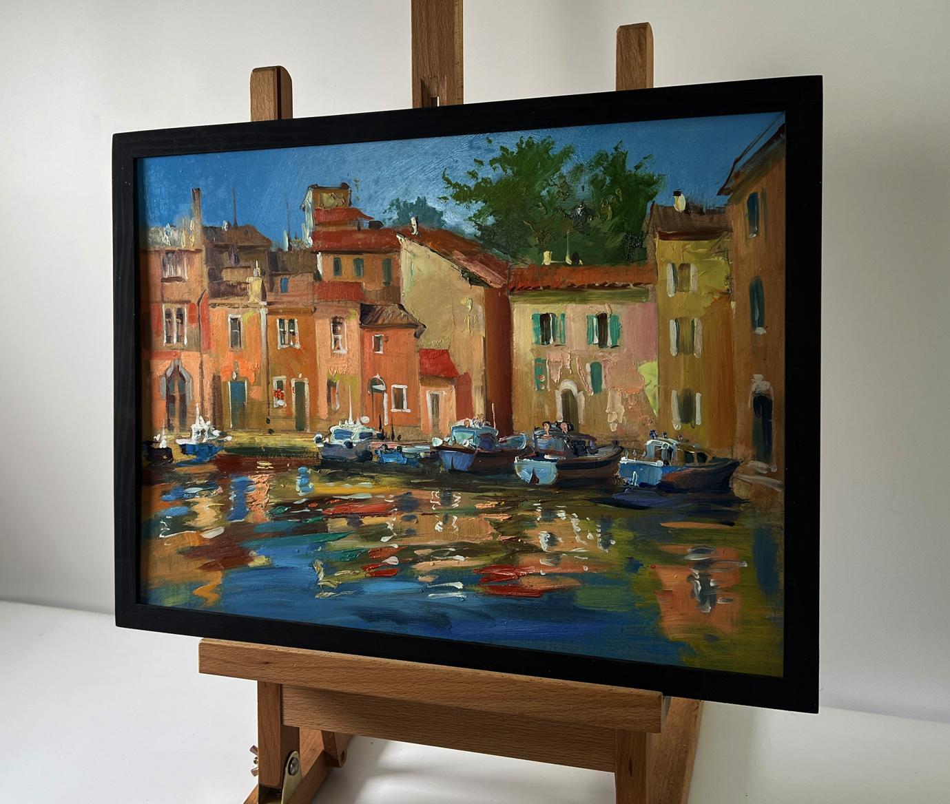 Framed oil painting of sunlit Venice canal by Yuriy Suprunchuk on easel