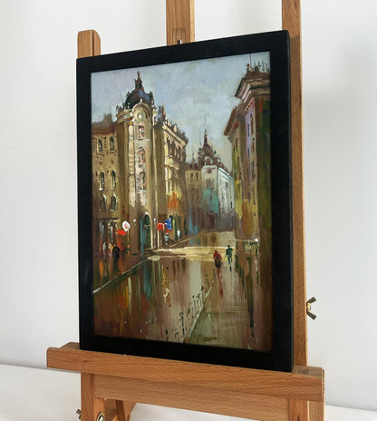 Framed oil painting of rainy old town street by Yuriy Suprunchuk