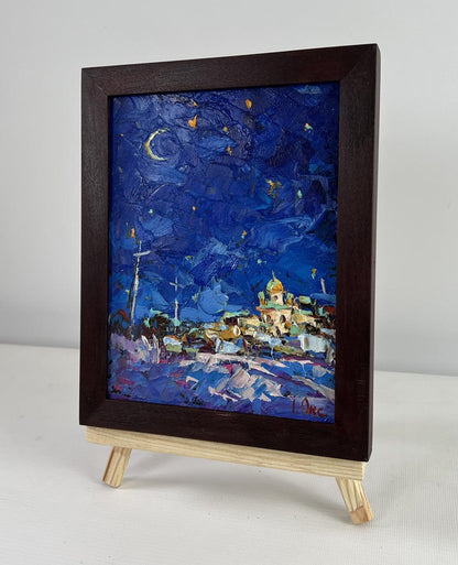 Dark wood-framed oil painting of moonlit starry night over village by Oksana Ivanyuk