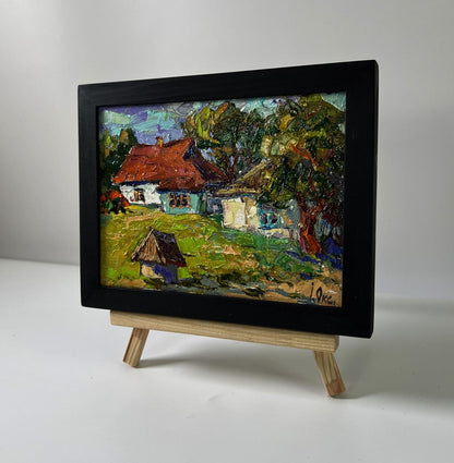 Quiet village courtyard oil painting by Oksana Ivanyuk in black frame
