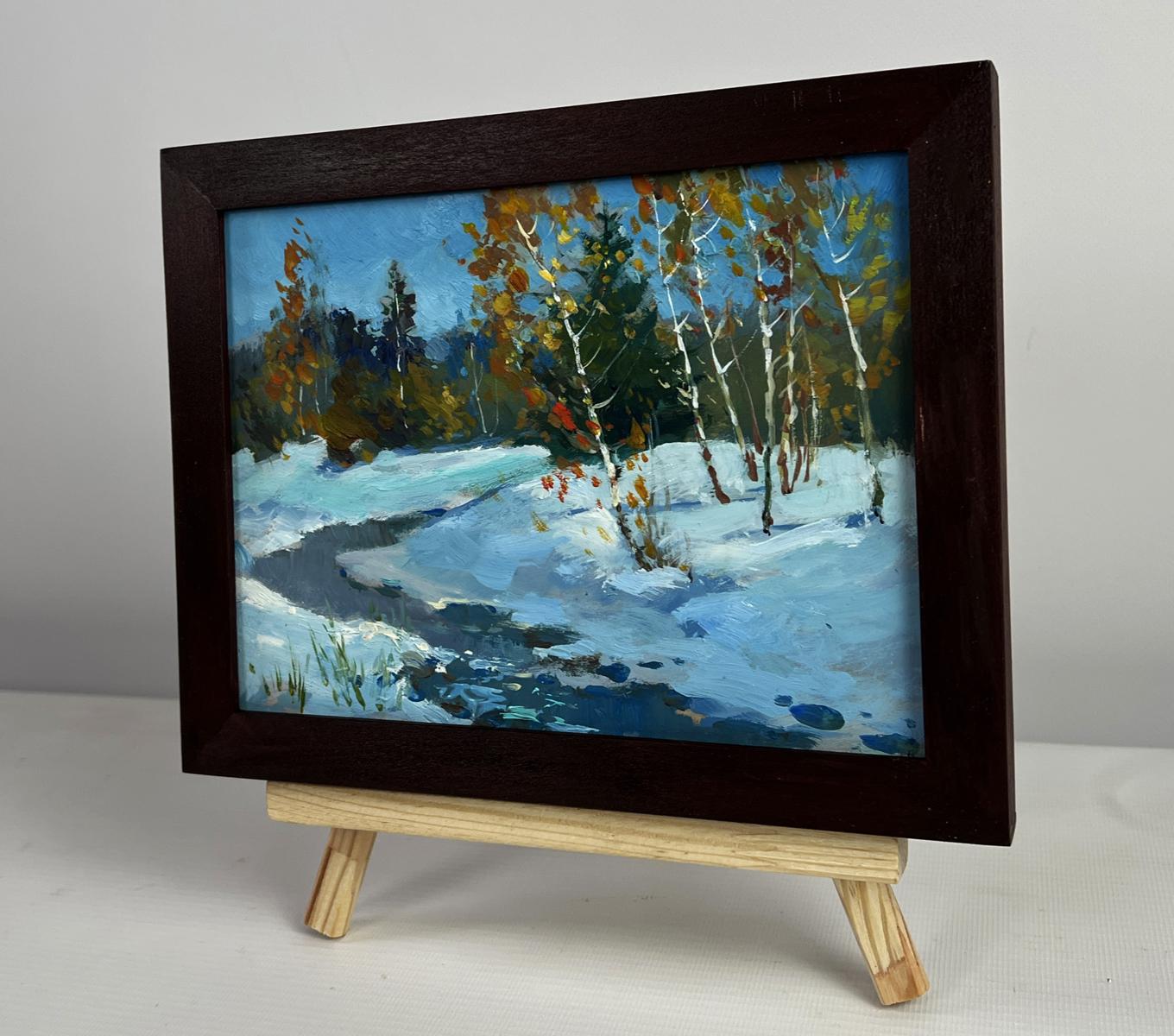 Dark wood-framed oil painting of snowy birch forest by Yuriy Suprunchuk on easel