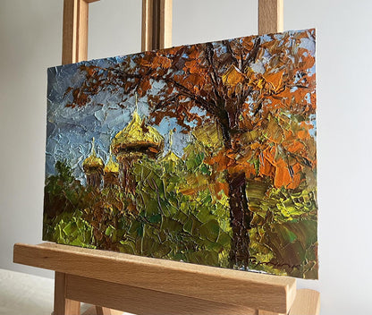 Oil painting Golden domes behind the trees by Boris Serdyuk on easel