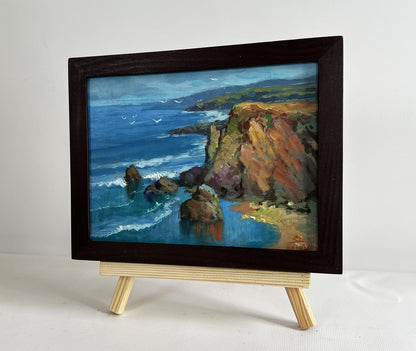 Oil painting by Yuriy Suprunchuk: waves crashing on rocks in wooden frame