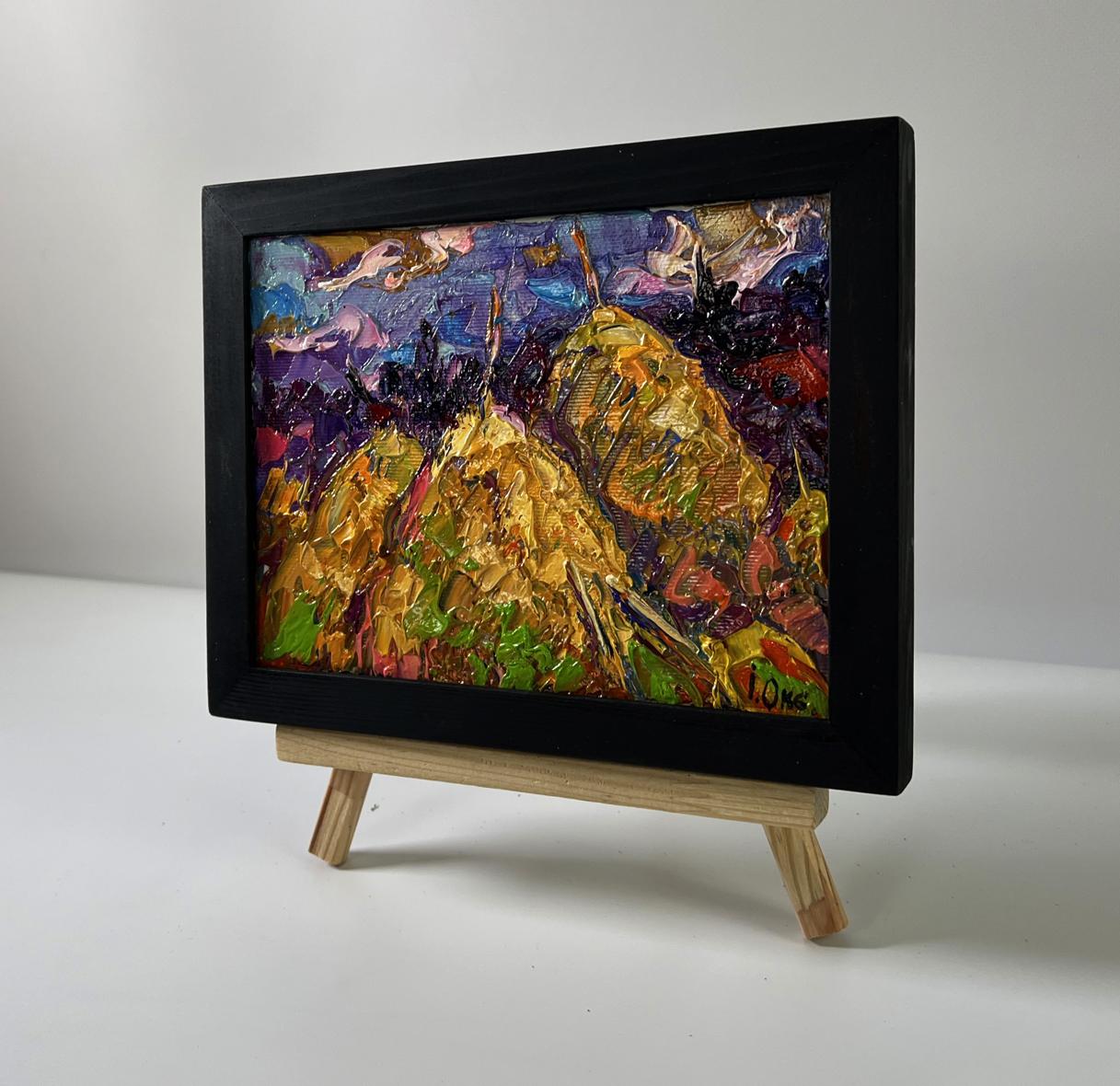 Oil painting Field with hay by Oksana Ivanyuk in black frame on easel
