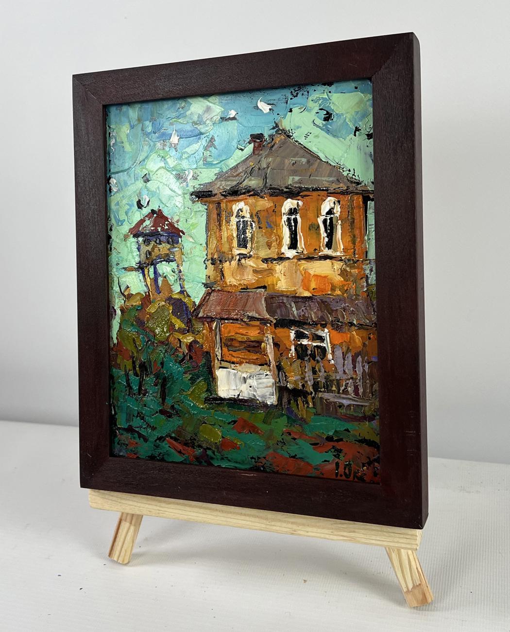Rustic oil painting of orange two-story house by Oksana Ivanyuk in dark frame