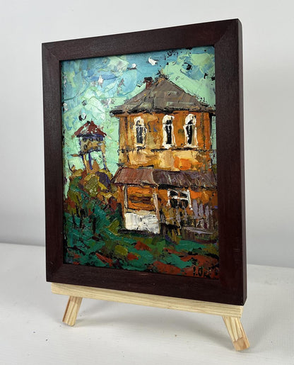 Rustic oil painting of orange two-story house by Oksana Ivanyuk in dark frame