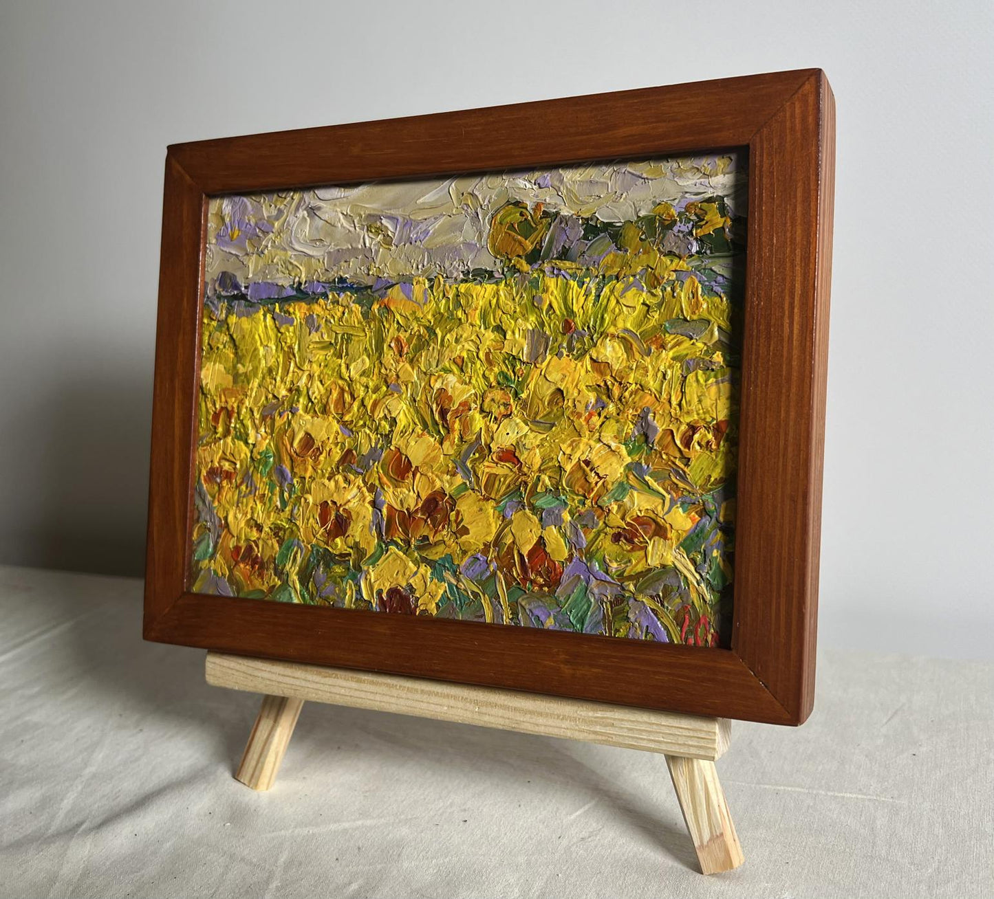 Vibrant oil painting of sunflower field by Oleksiy Ivanyuk in wooden frame