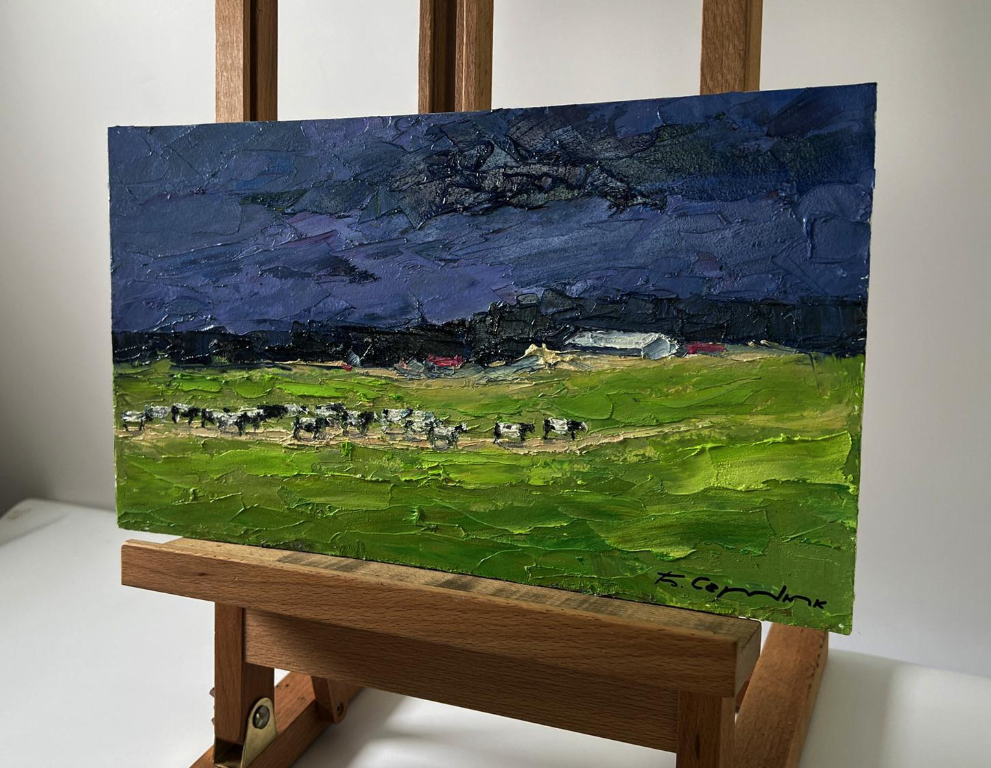 Oil painting Evening field by Boris Serdyuk: green field with cows under dark blue sky