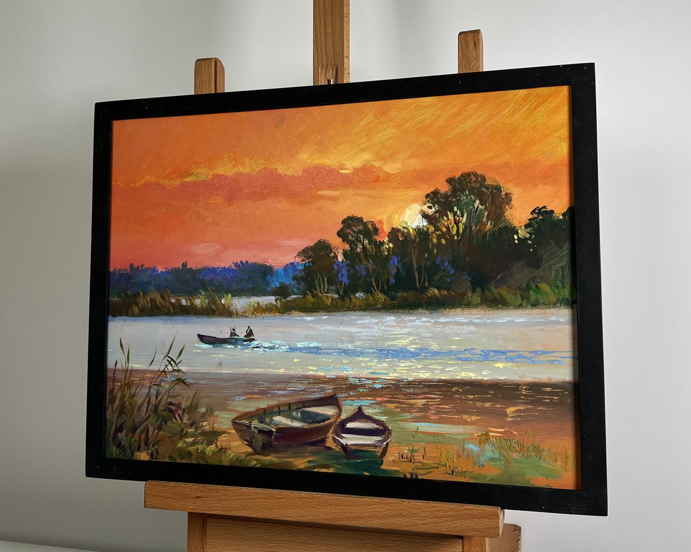 Oil painting Mesmerizing Crimson Sunset by Yuriy Suprunchuk in black frame on easel