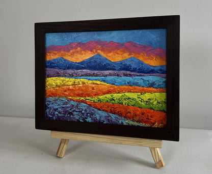 Oil painting of orange sunset behind mountains by V. Zadorozhnya in dark frame