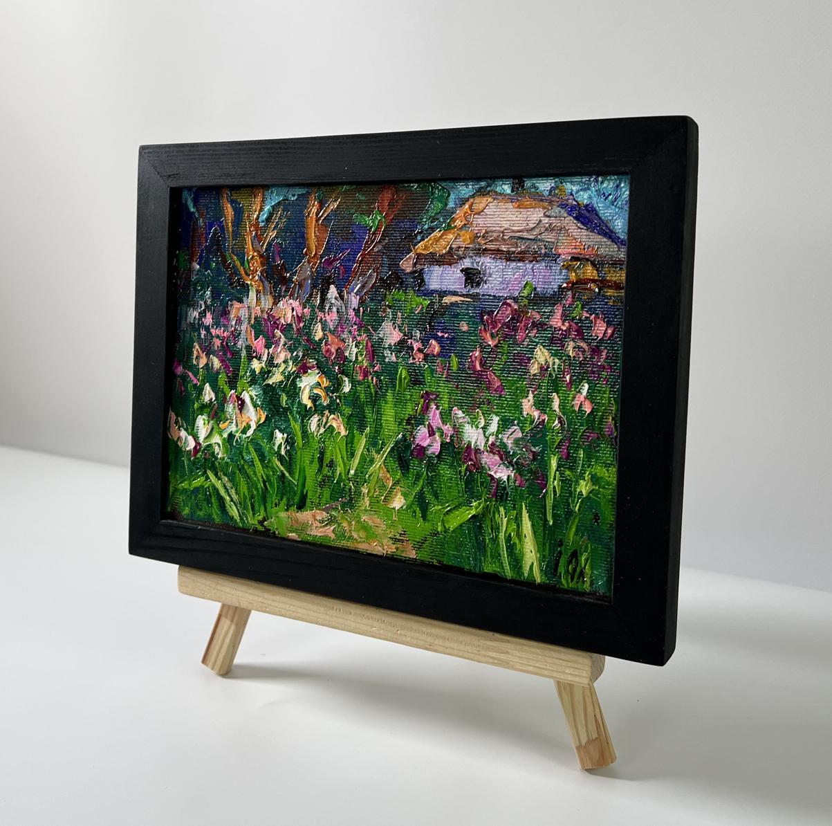 Black-framed miniature oil painting of irises and rustic cottage by Oleksiy Ivanyuk