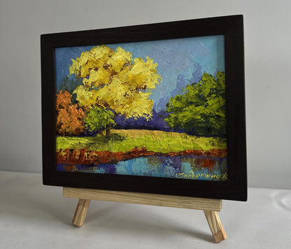 Vibrant impressionist oil painting by V. Zadorozhnya: yellow autumn forest tree reflected in water