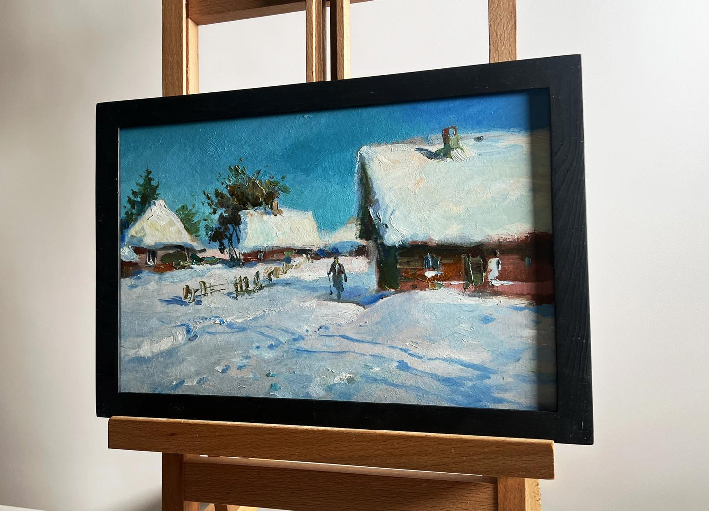 Framed oil painting by Yuriy Suprunchuk of snowy village clearing yard