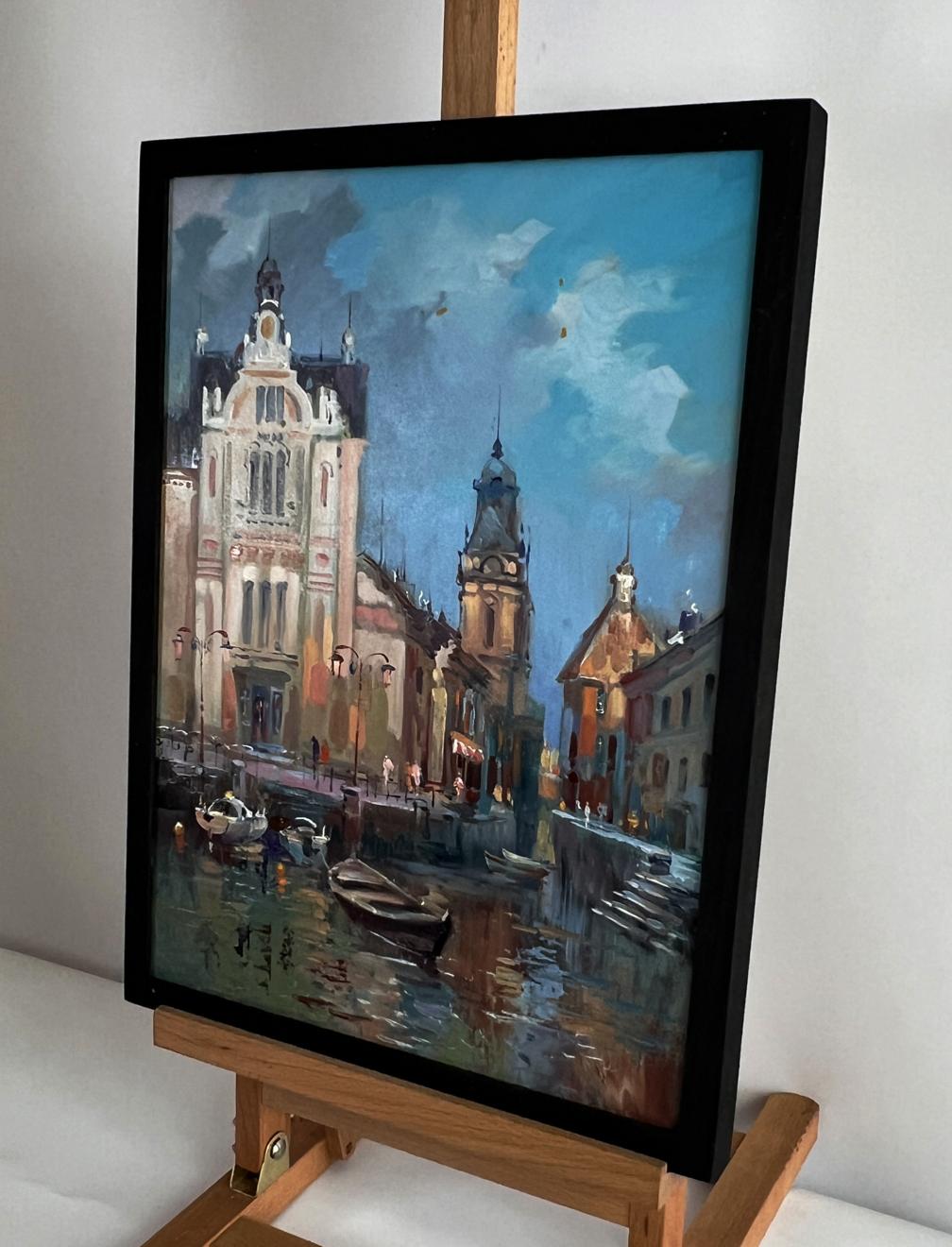 Oil painting of European cityscape with river and boats by Yuriy Suprunchuk in black frame