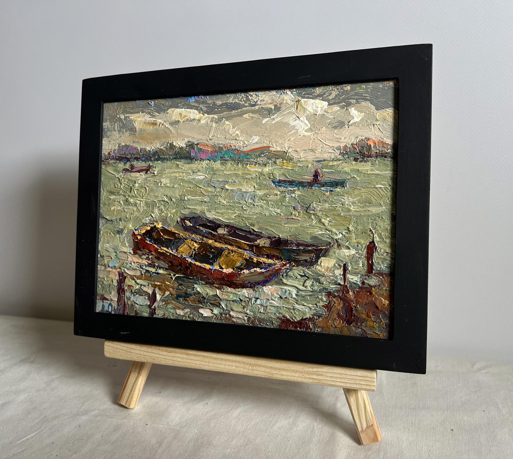 Oil painting of boats near pier by Oksana Ivanyuk in black frame