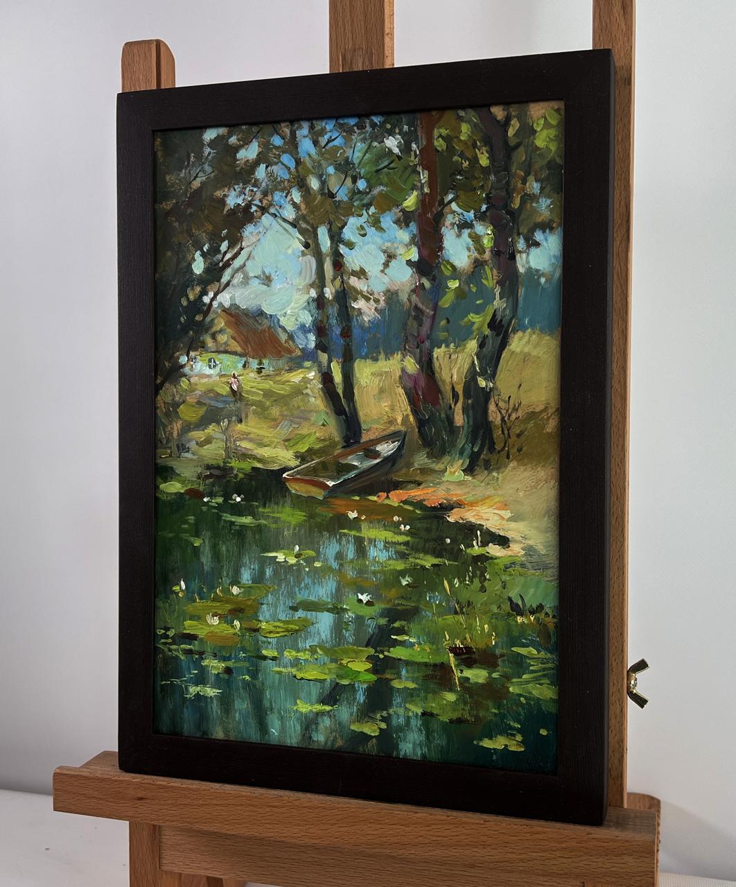 Framed oil painting of serene lakeside with lily pads, boat by Yuriy Suprunchuk