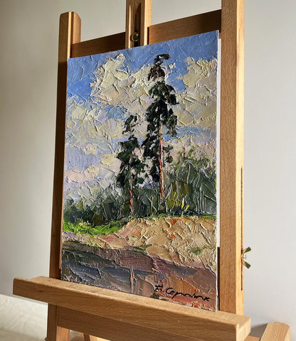 Oil painting Sand cliff by the river by Boris Serdyuk, tall green trees blue sky
