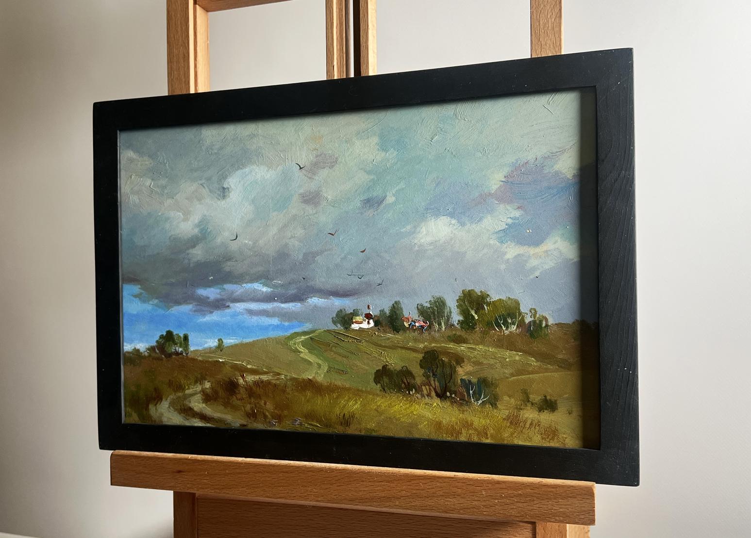 Oil painting by Yuriy Suprunchuk: countryside path, trees, building under grey clouds