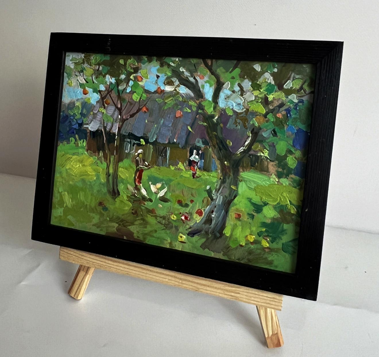 Vibrant impressionist oil painting by Yuriy Suprunchuk of countryside apple tree scene in black frame