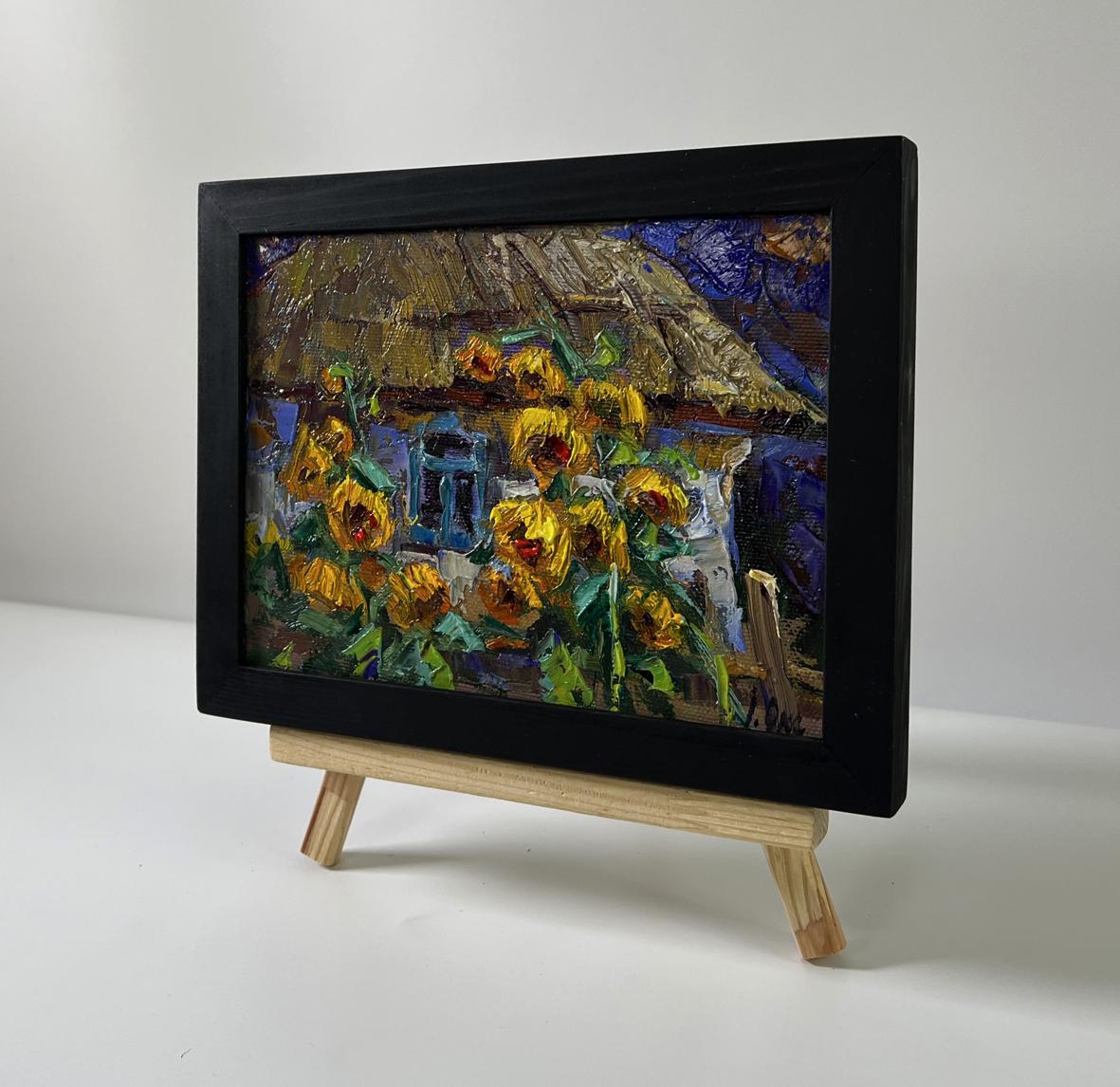 Oil painting Evening sunflowers by Oksana Ivanyuk in black frame on easel