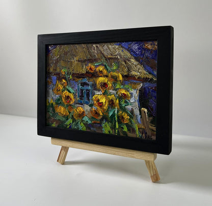 Oil painting Evening sunflowers by Oksana Ivanyuk in black frame on easel
