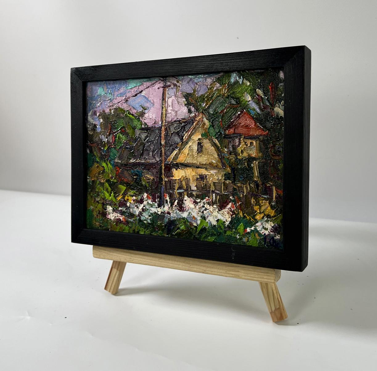Black-framed oil painting Evening house by Oksana Ivanyuk, rustic village scene