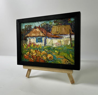 Vibrant impressionist oil painting by Oksana Ivanyuk: village courtyard in black frame