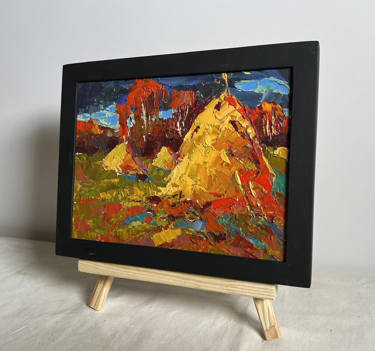 Oil painting Autumn fields and haystacks by Oleksiy Ivanyuk in black frame