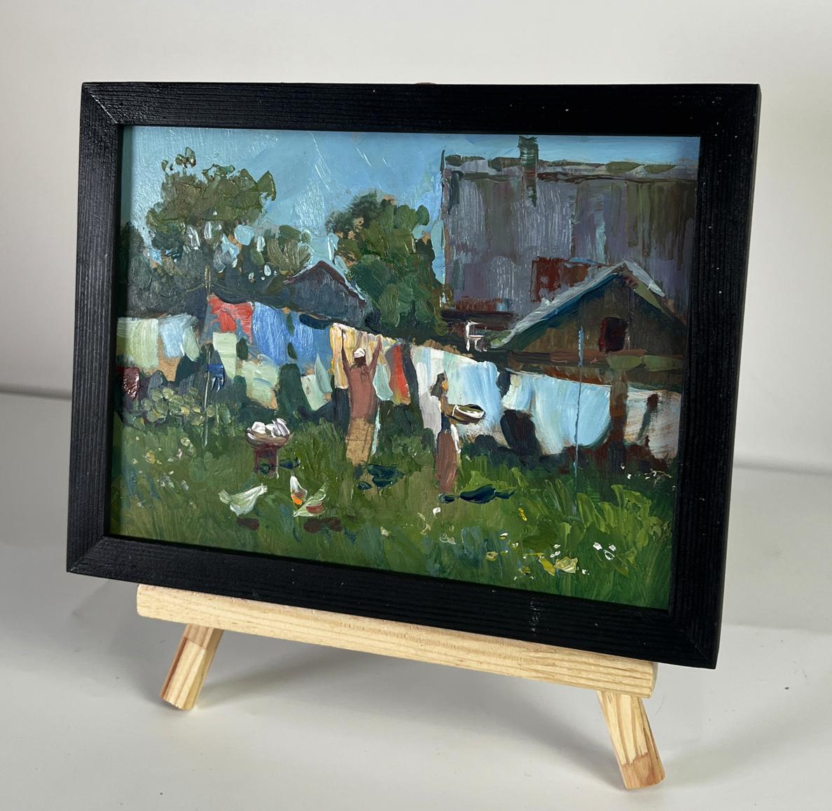 Black-framed oil painting of daytime rural village by Yuriy Suprunchuk
