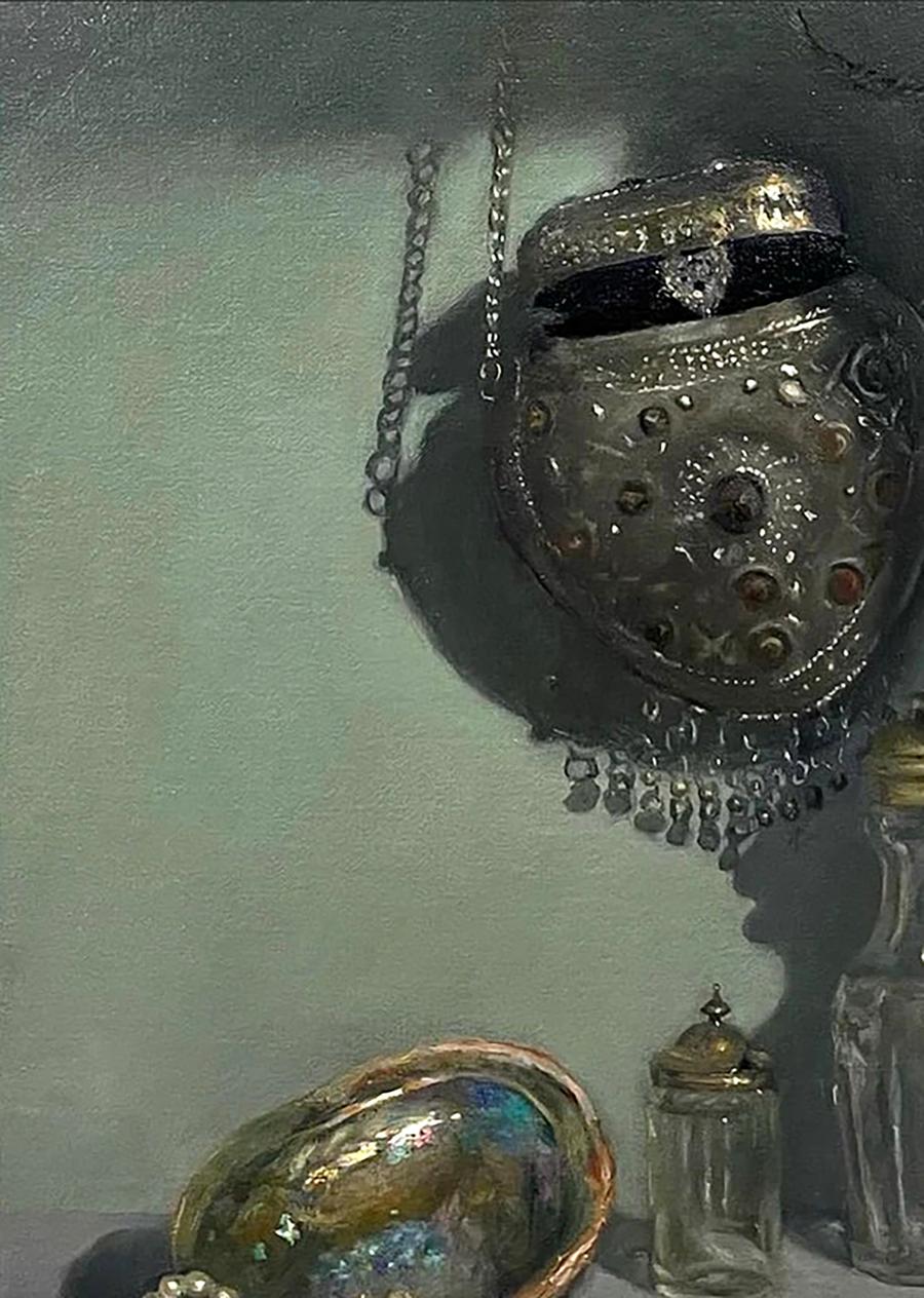 Silver ornate pouch with embossed patterns in Annam Butt pearl glass still life