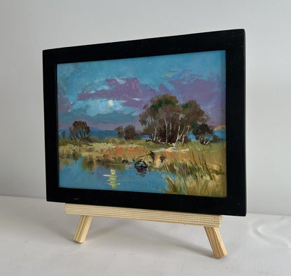Framed oil painting of serene lakeside field by Yuriy Suprunchuk
