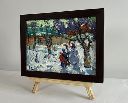 Oil painting by Oksana Ivanyuk: children making snowman in snowy scene