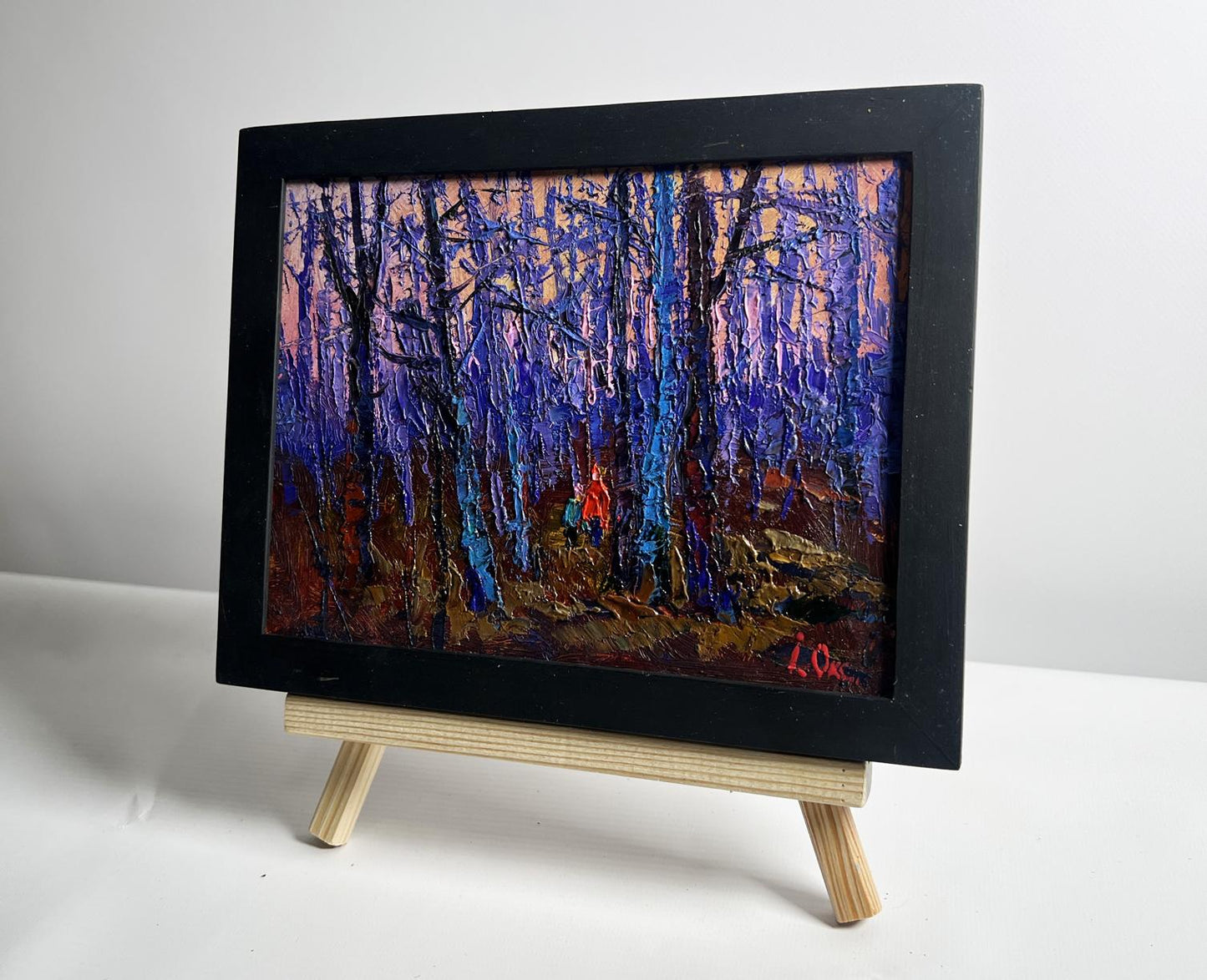 Oil painting of frosty forest with blue trees by Oksana Ivanyuk