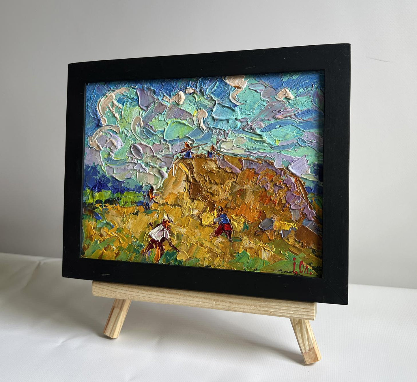 Oil painting Working in the field with hay by Oleksiy Ivanyuk in black frame