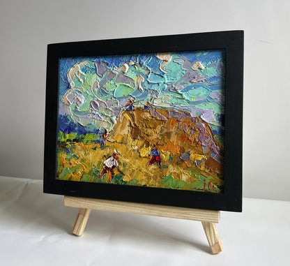 Oil painting Working in the field with hay by Oleksiy Ivanyuk in black frame