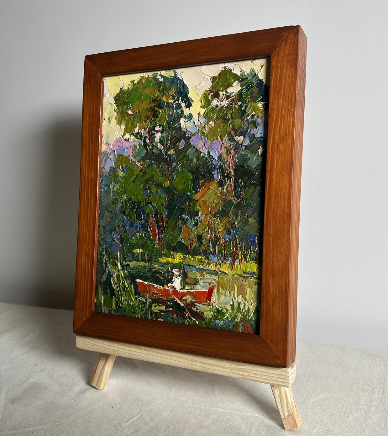 Rustic forest oil painting with red canoe by Oksana Ivanyuk on easel
