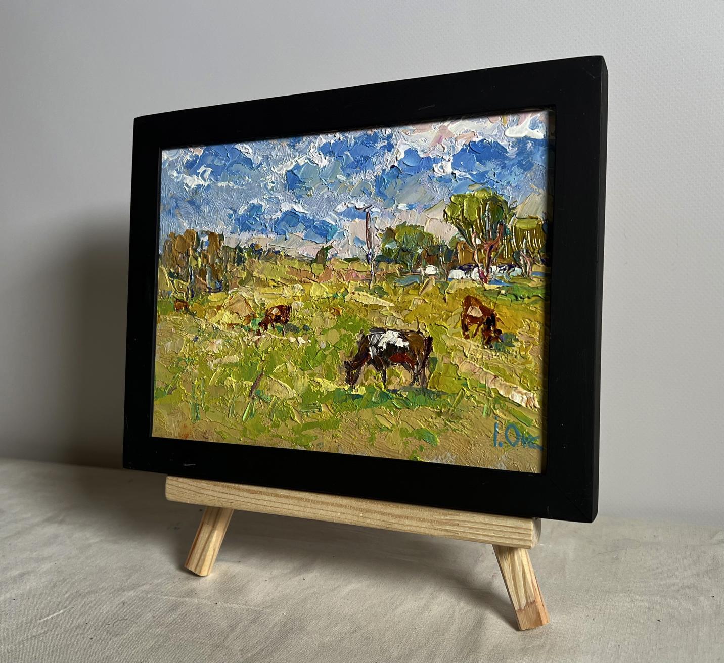 Framed oil painting of cows grazing in field by Oksana Ivanyuk