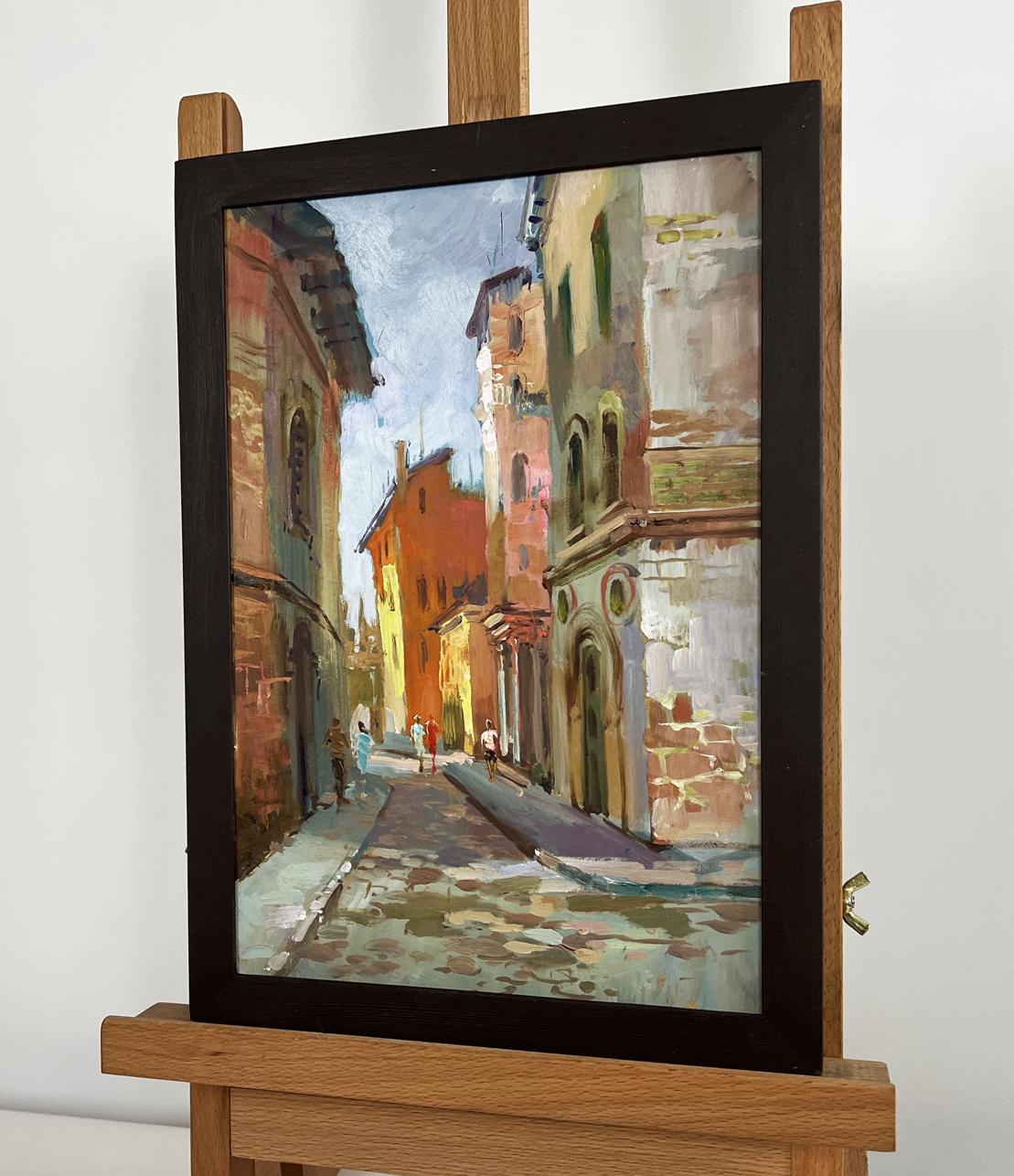 Framed oil painting of sunlit cobblestone street by Yuriy Suprunchuk