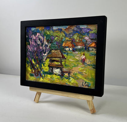 Oil painting Earth awakens to new life by Oksana Ivanyuk in black frame