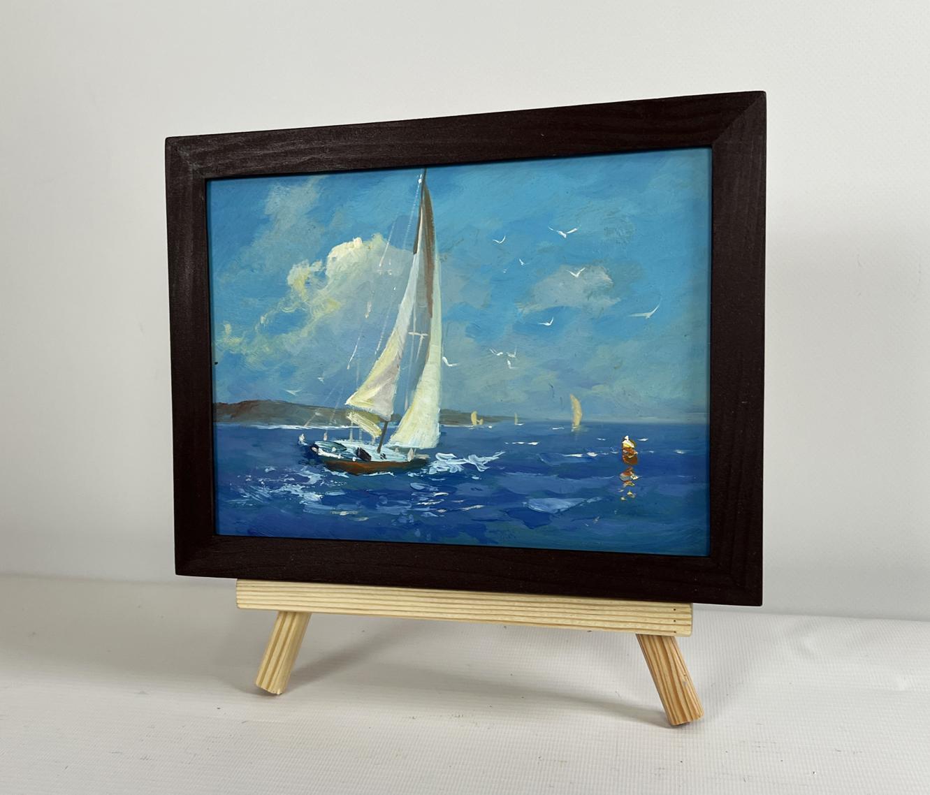 Framed oil painting of sailboat on blue water by Yuriy Suprunchuk