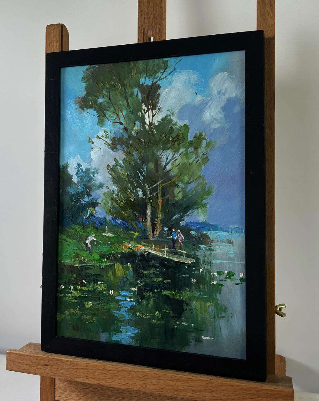 Oil painting of bridge over river with people by Yuriy Suprunchuk in black frame
