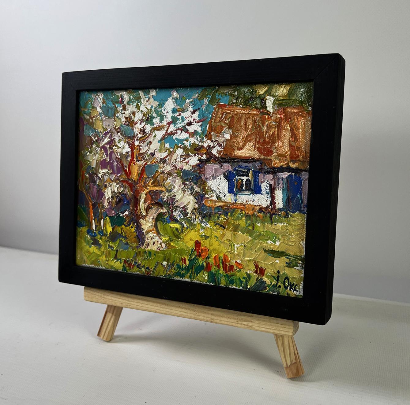 Vibrant impressionist oil painting by Oksana Ivanyuk of bright day cottage in black frame