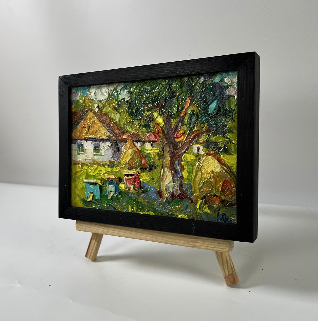 Oil painting of village yard with apiary by Oksana Ivanyuk in black frame
