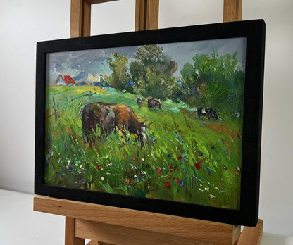 Framed impressionist oil painting of cows in flower field by Yuriy Suprunchuk