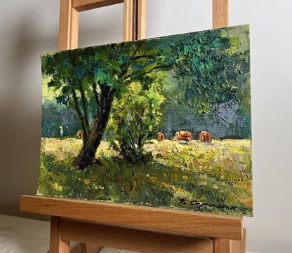 Vibrant impressionist oil painting of cows grazing under tree by Boris Serdyuk