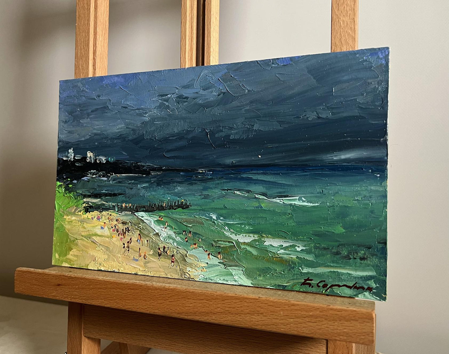 Oil painting of people on stormy beach by Boris Serdyuk