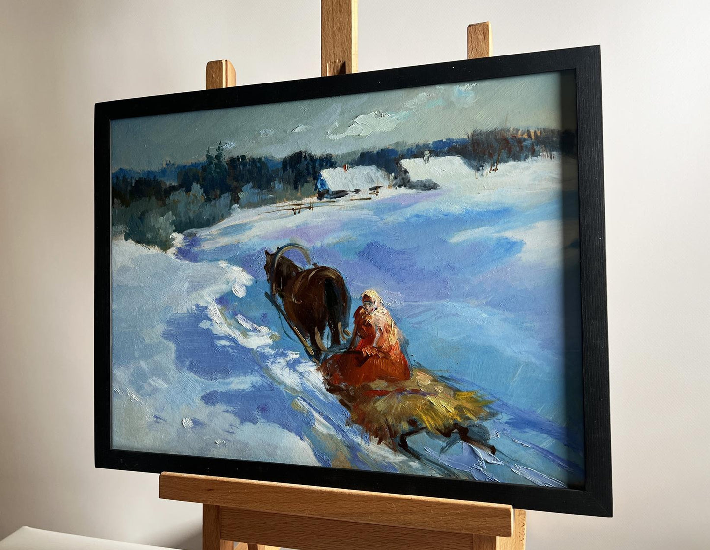 Black-framed oil painting Returning home on a winter evening by Yuriy Suprunchuk