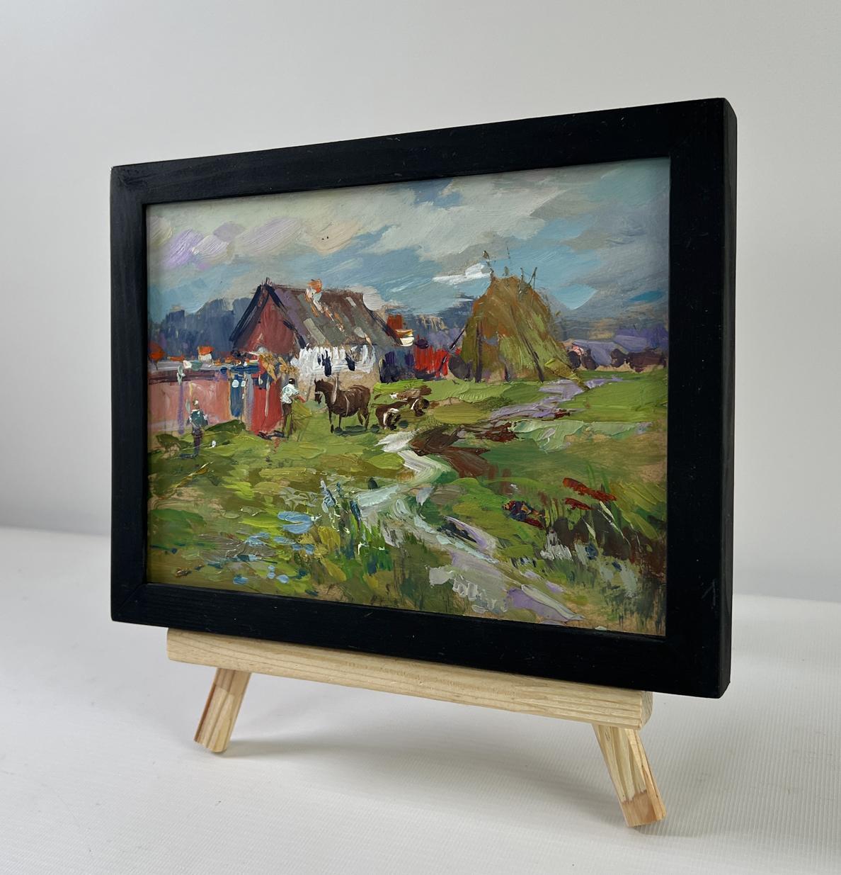 Oil painting of horses by hay bales in rustic village by Yuriy Suprunchuk